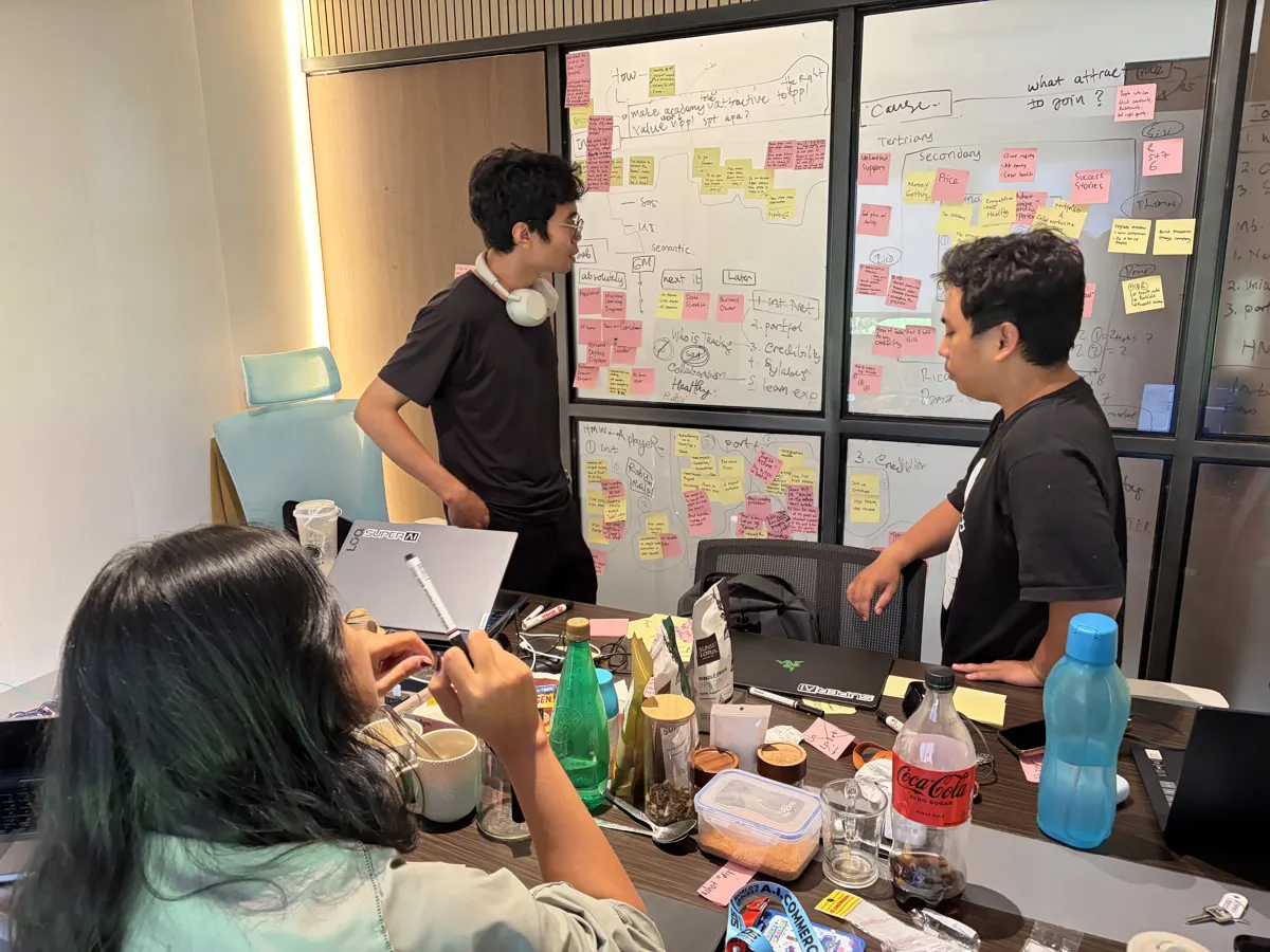 The team breaking a problem down on a sticky-note wall